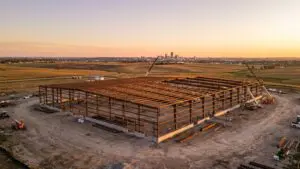 Steel frame of a light-industrial building under construction on the edge of Omaha at sunrise